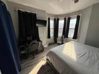a bedroom with a bed and two windows at EWRBNB - Private Bedroom in Well sized Shared Apartment - 1 in Elizabeth