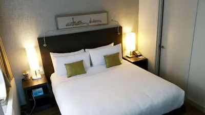 a bedroom with a large white bed with two lamps at The Bernic Hotel New York City,Tapestry Collection by Hilton in New York