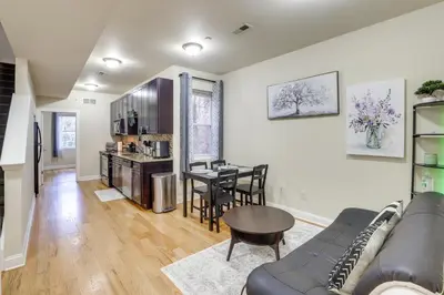 a living room and kitchen with a couch and a table at Spectacular 5BAand2BA Group Getaway in Philly! in Philadelphia