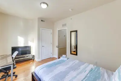 a bedroom with a bed and a desk and a television at Spectacular 5BAand2BA Group Getaway in Philly! in Philadelphia