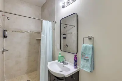 a bathroom with a sink and a shower and a mirror at Spectacular 5BAand2BA Group Getaway in Philly! in Philadelphia