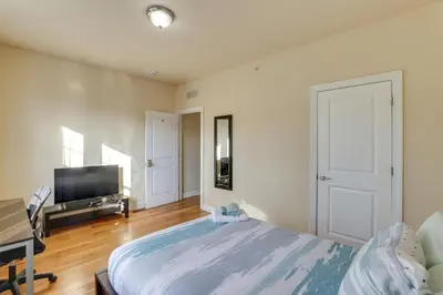 a bedroom with a large bed and a flat screen tv at Spectacular 5BAand2BA Group Getaway in Philly! in Philadelphia