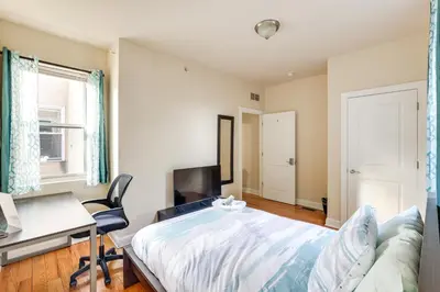 a bedroom with a bed and a desk and a desk at Spectacular 5BAand2BA Group Getaway in Philly! in Philadelphia