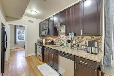 a kitchen with wooden cabinets and a counter top at Spectacular 5BAand2BA Group Getaway in Philly! in Philadelphia