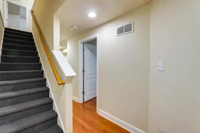 a staircase in a house with a hallway and a door at Spacious 4BRand2BA Family Retreat in Philadelphia in Philadelphia