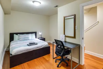 a bedroom with a bed and a desk and a mirror at Spacious 4BRand2BA Family Retreat in Philadelphia in Philadelphia