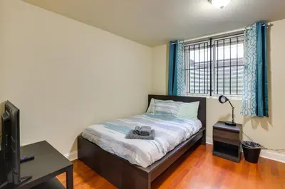 a bedroom with a bed and a tv and a window at Spacious 4BRand2BA Family Retreat in Philadelphia in Philadelphia