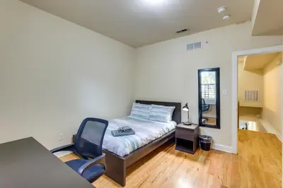 a bedroom with a bed and a chair in it at Spacious 4BRand2BA Family Retreat in Philadelphia in Philadelphia