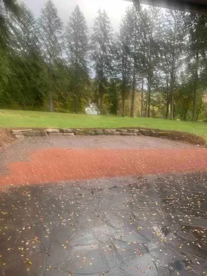 a puddle of red water with trees in the background at The Big House at Elk Creek Escape in Hillsgrove