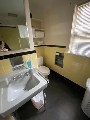 a bathroom with a sink and a toilet and a mirror at The Big House at Elk Creek Escape in Hillsgrove