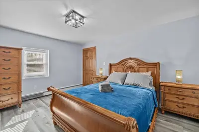 a bedroom with a bed and a dresser at Cozy Farmhouse - Fireplace, Backyard, BBQ, Games - 3 MIN TO CAMELBACK in Tannersville