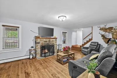 a living room with a couch and a fireplace at Cozy Farmhouse - Fireplace, Backyard, BBQ, Games - 3 MIN TO CAMELBACK in Tannersville