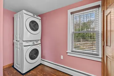 a washer and dryer in a pink room with a window at Cozy Farmhouse - Fireplace, Backyard, BBQ, Games - 3 MIN TO CAMELBACK in Tannersville