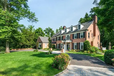 a large brick house with a driveway at Luxury Princeton Estate Pool, Hot Tub, Sleeps 20 in Princeton