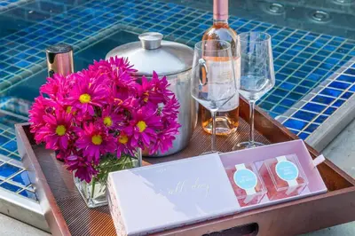 a table with flowers and wine glasses and a box at Luxury Princeton Estate Pool, Hot Tub, Sleeps 20 in Princeton