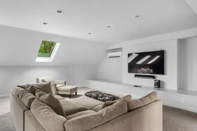a living room with a couch and a tv at Luxury Princeton Estate Pool, Hot Tub, Sleeps 20 in Princeton