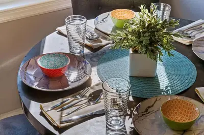 a table with plates and bowls and a plant on it at 3BR Home 2 Baths Bonus Room, Minutes to NYC in Hackensack