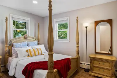 a bedroom with a large bed and a mirror at 3BR Home 2 Baths Bonus Room, Minutes to NYC in Hackensack