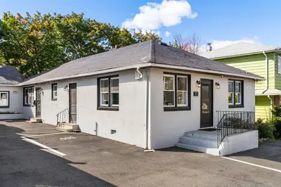 a white house with a parking lot at 3BR Home 2 Baths Bonus Room, Minutes to NYC in Hackensack