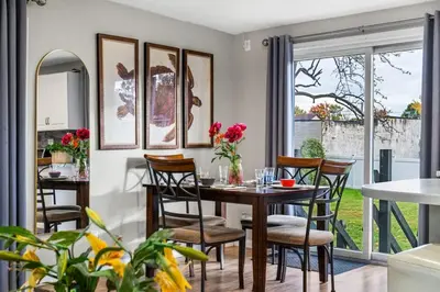 a dining room with a table and chairs at 4BR Home Minutes to NYC Time Square in Teaneck