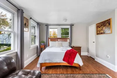 a bedroom with a bed with a red blanket on it at 4BR Home Minutes to NYC Time Square in Teaneck