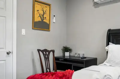 a bedroom with a table and a bed and a desk at 4BR Home Minutes to NYC Time Square in Teaneck