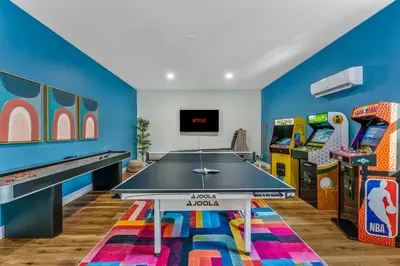 a play room with a ping pong table and arcade games at Emerald Luxe Retreat Lake Hot Tub Sauna in Long Pond