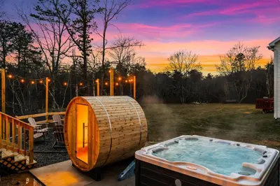 a hot tub in a yard with a sunset at Emerald Luxe Retreat Lake Hot Tub Sauna in Long Pond