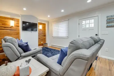 a living room with two couches and a tv at Waterfront Arrowhead Lake Retreat with Resort Perks! in Pocono Lake
