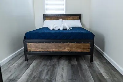 a bed with two white towels on top of it at Cozy Urban Oasis Near NYC in West New York