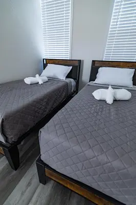 two beds sitting next to each other in a bedroom at Cozy Urban Oasis Near NYC in West New York