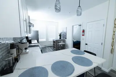 a white table with blue circles on it in a room at Cozy Urban Oasis Near NYC in West New York