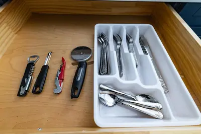 a white tray with utensils on a wooden table at Cozy Urban Oasis Near NYC in West New York