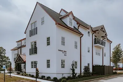 a white building with a black roof at Normandy Farm Hotel & Conference Center in Blue Bell