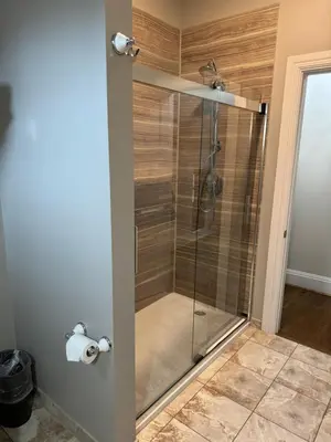a shower with a glass door in a bathroom at Normandy Farm Hotel & Conference Center in Blue Bell