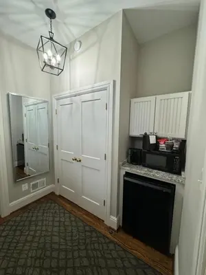 a kitchen with a white door and a microwave at Normandy Farm Hotel & Conference Center in Blue Bell