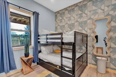 a bedroom with a bunk bed in a room at Lakefront AFrame, Heated Pool, Spa, Sauna, Theatre in Blakeslee