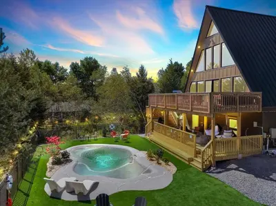 an aerial view of a house with a swimming pool at Lakefront AFrame, Heated Pool, Spa, Sauna, Theatre in Blakeslee