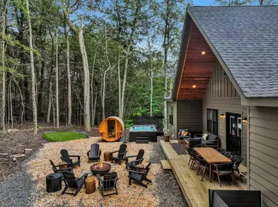 a backyard with a pool table and chairs at Golf Sim, Game-Movie Room, Spa, Sauna, Arcade ! in Tobyhanna