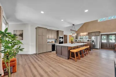 a large kitchen with a large island in a room at Golf Sim, Game-Movie Room, Spa, Sauna, Arcade ! in Tobyhanna