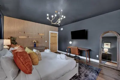 a bedroom with a large bed and a television at Golf Sim, Game-Movie Room, Spa, Sauna, Arcade ! in Tobyhanna