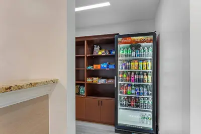 a refrigerator filled with lots of drinks in a room at Comfort Inn in Staten Island