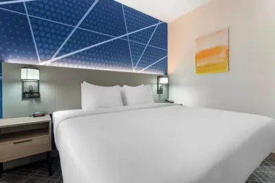 a hotel room with a large bed and a desk at Comfort Inn in Staten Island