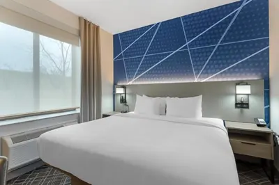 a hotel room with a large bed and a window at Comfort Inn in Staten Island