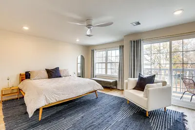 a bedroom with a bed and a chair and windows at Walk to Keansburg Beach! Family Home with Pool in Keansburg
