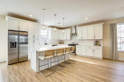 a kitchen with white cabinets and stainless steel appliances at Walk to Keansburg Beach! Family Home with Pool in Keansburg