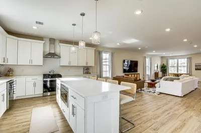 an open kitchen and living room with white cabinets at Walk to Keansburg Beach! Family Home with Pool in Keansburg