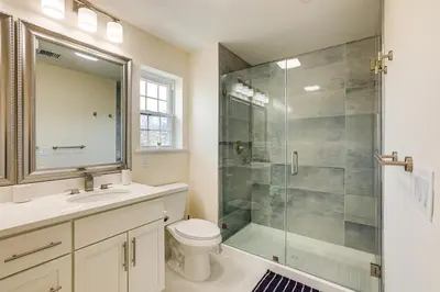 a bathroom with a shower and a toilet and a sink at Walk to Keansburg Beach! Family Home with Pool in Keansburg