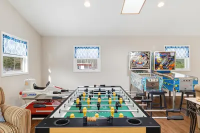 a living room with a foosball table at The Rock Oak Escape in Dingmans Ferry