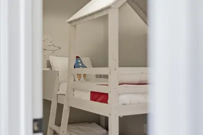 a white bunk bed with a ladder in a room at The Rock Oak Escape in Dingmans Ferry
